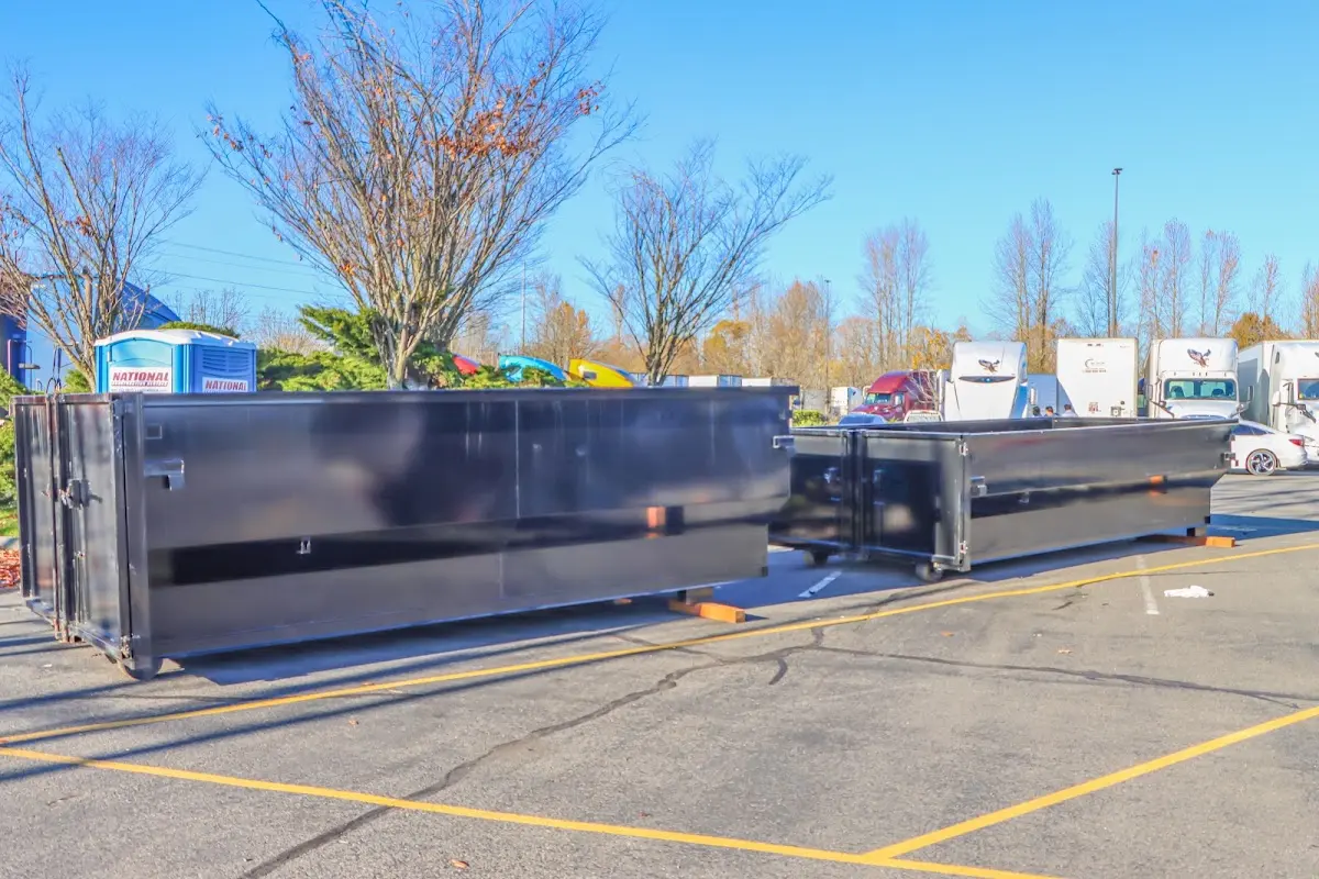 Professional dumpster rental service with roll-off container on residential driveway in Oakley